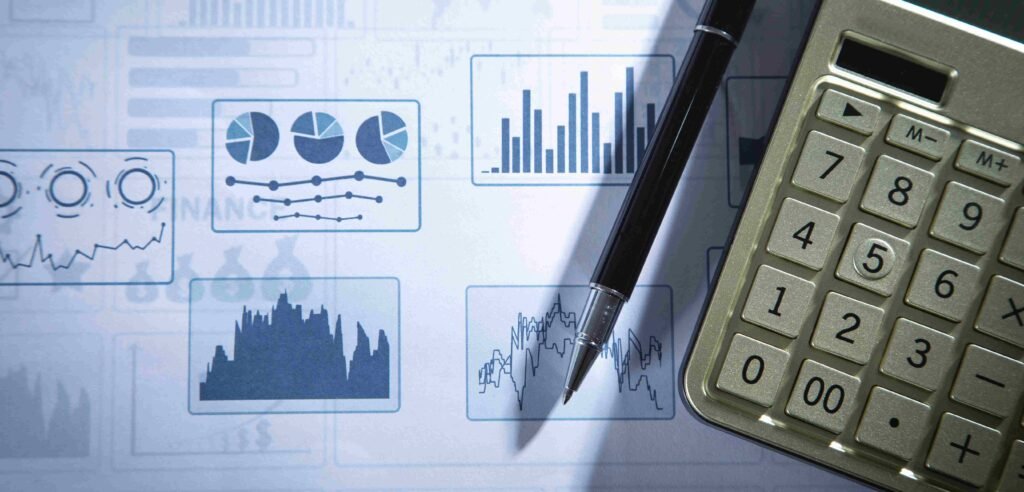 Financial modeling charts with calculator and pen used for financial analysis
