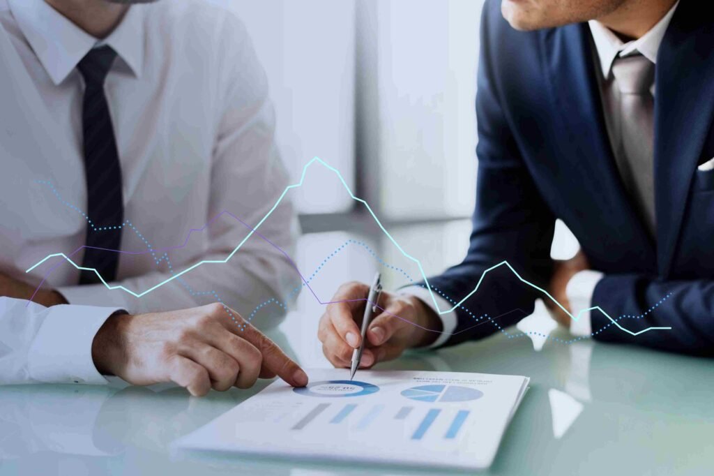Two business professionals reviewing financial charts with performance lines overlaid