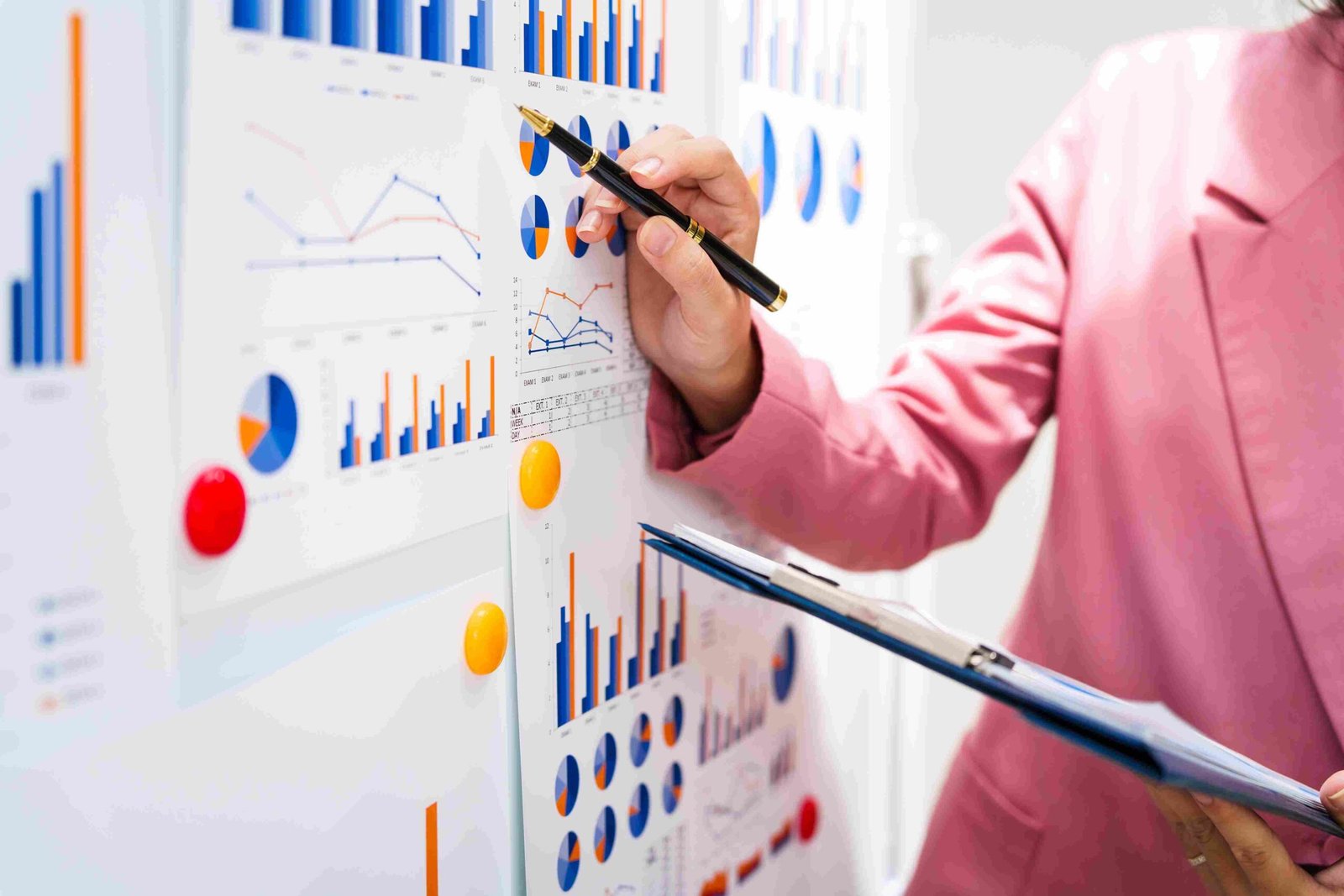 Business professional reviewing charts and financial ratio reports on a presentation board