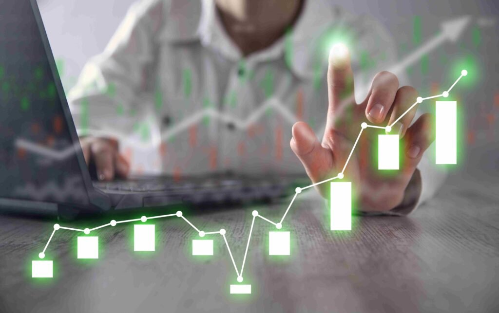 Growth Drivers and Assumptions in Financial Planning: Person analyzing financial growth charts on a laptop with rising graph overlay