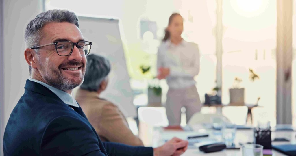 Professional attending a business meeting while listening to a presentation in a conference room
