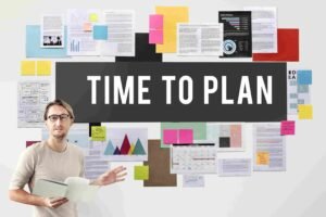 Professional presenting a headcount planning board filled with charts, schedules, notes, and workforce planning documents