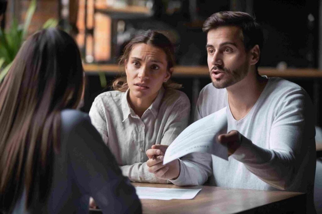 Clients meeting with a financial advisor to discuss documents and compare financial planning options