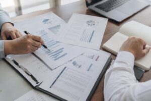 Investment consultants reviewing financial charts and portfolio reports